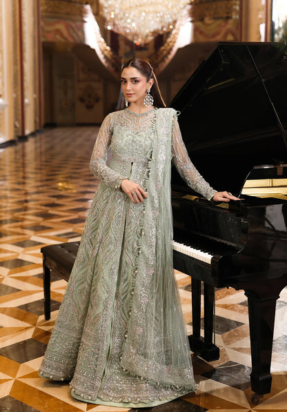 Woman in a traditional outfit standing next to a grand piano in an elegant interior setting.
