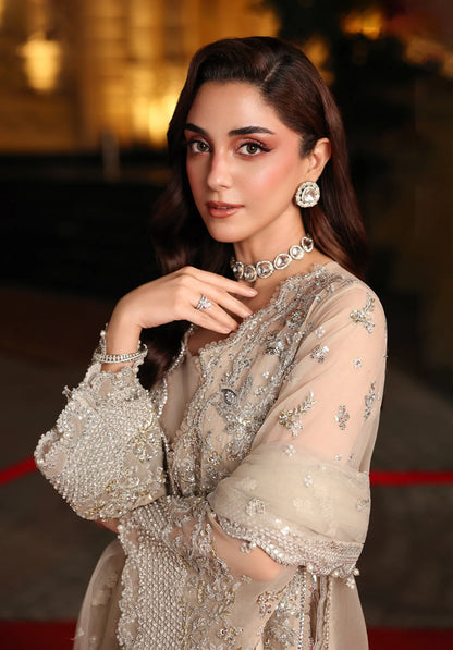 Woman in a silver embellished outfit on a red carpet with Elaf Stardom Handwork